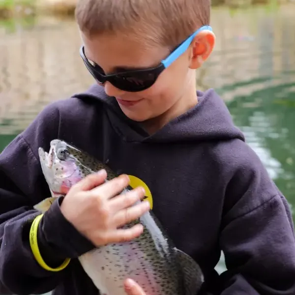 Child with rainbow trout 